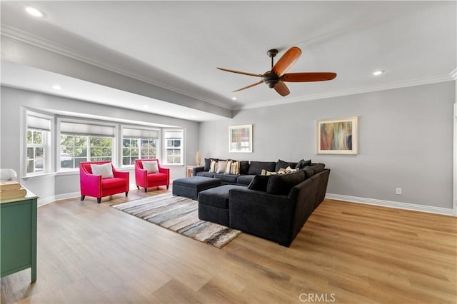 living area with baseboards, crown molding, recessed lighting, and light wood-style floors