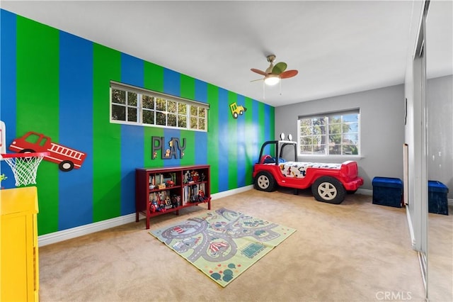 rec room featuring carpet floors, ceiling fan, and baseboards