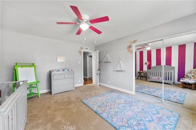 bedroom featuring carpet floors, a closet, a ceiling fan, and baseboards