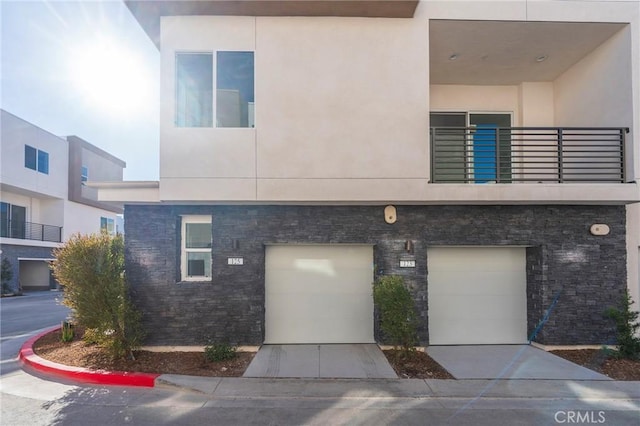 view of front of home featuring a balcony and a garage