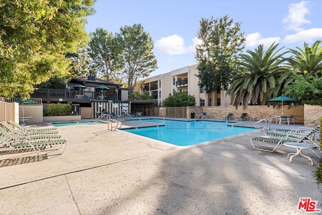 view of swimming pool with a patio area