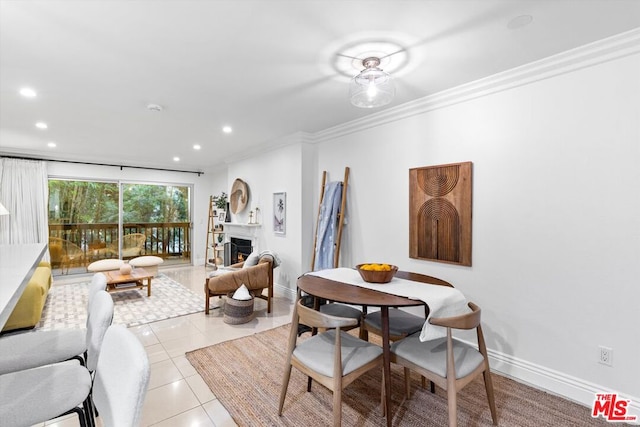 tiled dining room featuring crown molding