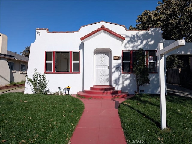 mediterranean / spanish-style home featuring a front lawn