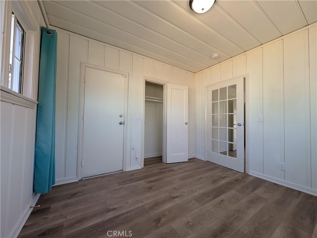 unfurnished bedroom featuring a closet and dark wood finished floors