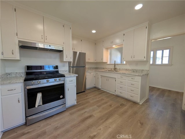 kitchen featuring appliances with stainless steel finishes, light wood-style flooring, white cabinetry, and under cabinet range hood