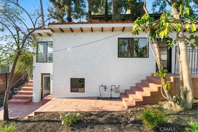 rear view of property featuring a patio