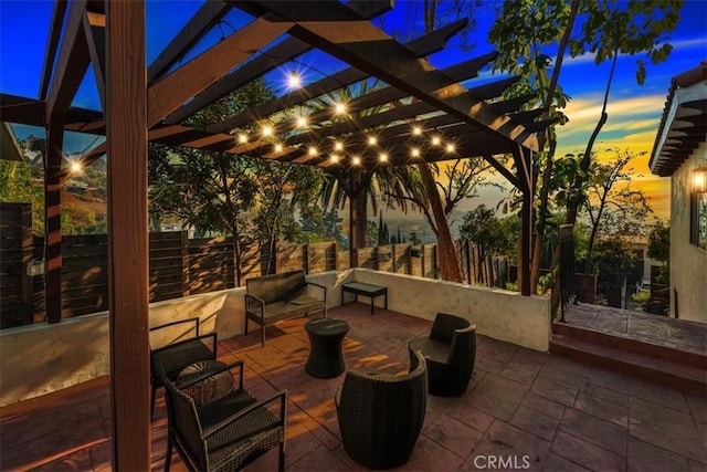 patio terrace at dusk with a pergola and an outdoor hangout area