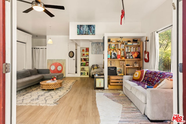 living room featuring ceiling fan and hardwood / wood-style floors