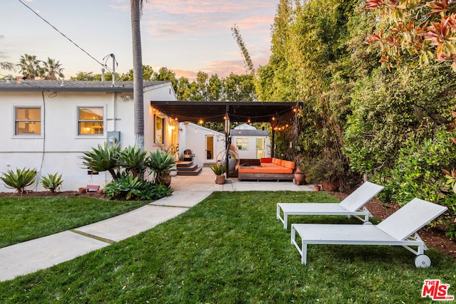 yard at dusk with an outdoor living space