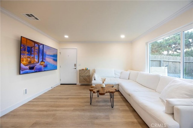 living room with crown molding and light hardwood / wood-style flooring