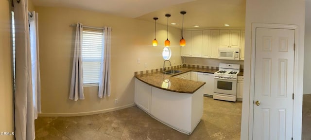 kitchen featuring sink, decorative light fixtures, white cabinets, white appliances, and kitchen peninsula