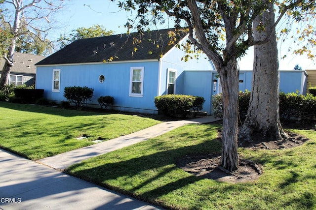 view of side of property with a yard