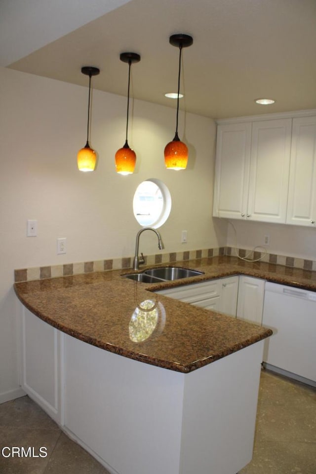 kitchen featuring light tile patterned floors, white dishwasher, pendant lighting, sink, and white cabinetry