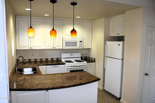 kitchen with white appliances, hanging light fixtures, kitchen peninsula, sink, and white cabinetry