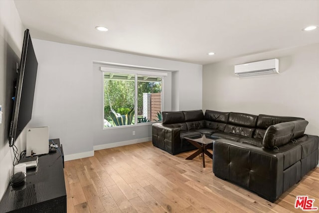 living room with light hardwood / wood-style flooring and a wall mounted air conditioner