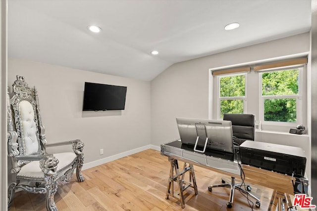 office with hardwood / wood-style floors and lofted ceiling