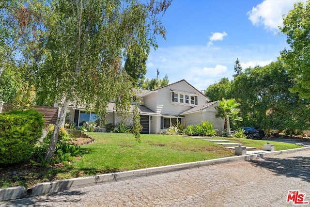 front facade with a front yard