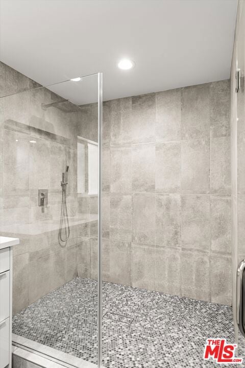 bathroom with an enclosed shower and vanity