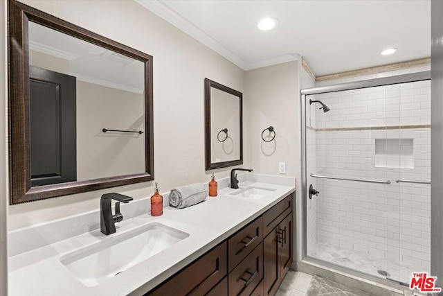 bathroom with an enclosed shower, vanity, and ornamental molding