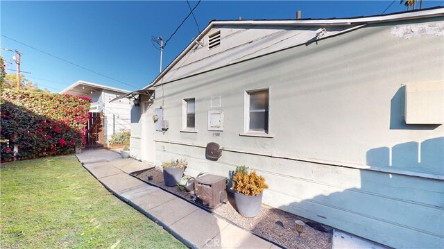 rear view of house featuring a yard