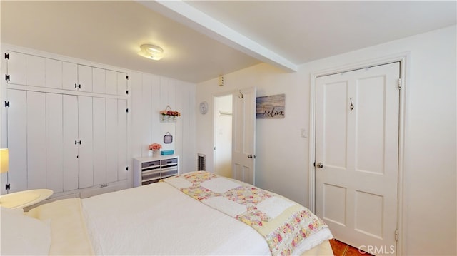 bedroom with a closet and beamed ceiling