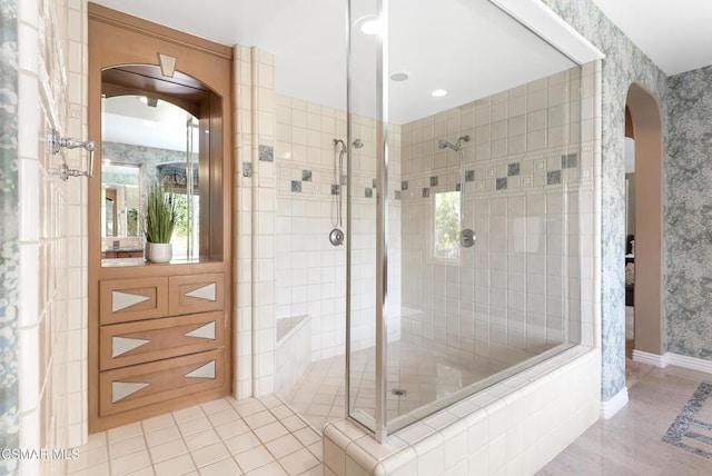 bathroom featuring a tile shower and tile patterned floors