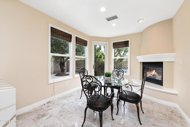 dining space with a large fireplace