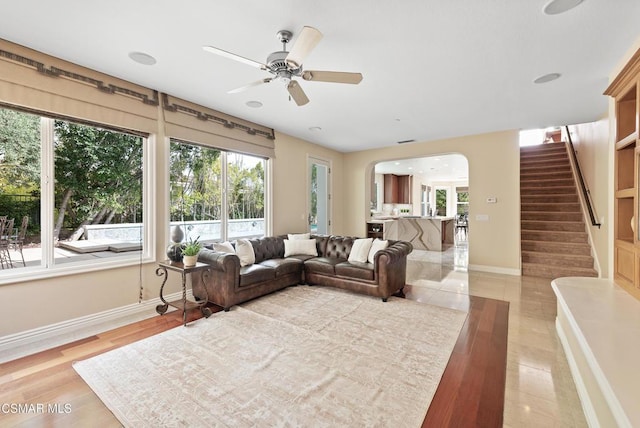 living room featuring ceiling fan and light wood-type flooring