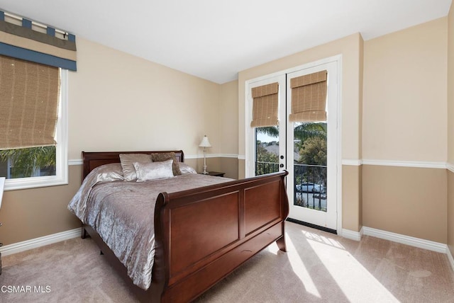 bedroom with light carpet and access to exterior