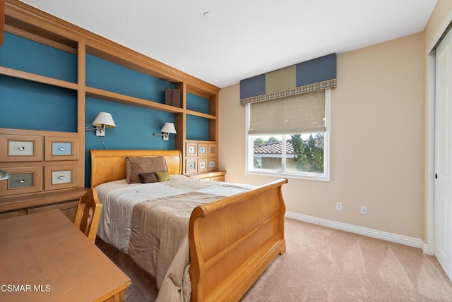 bedroom featuring light colored carpet and a closet