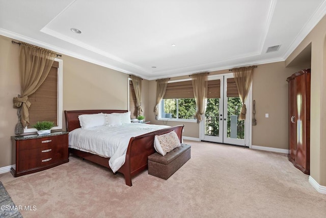 bedroom with access to exterior, ornamental molding, a tray ceiling, and light colored carpet