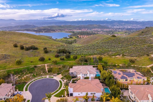 drone / aerial view featuring a water and mountain view