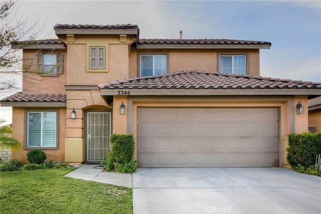 mediterranean / spanish house with a garage and a front lawn