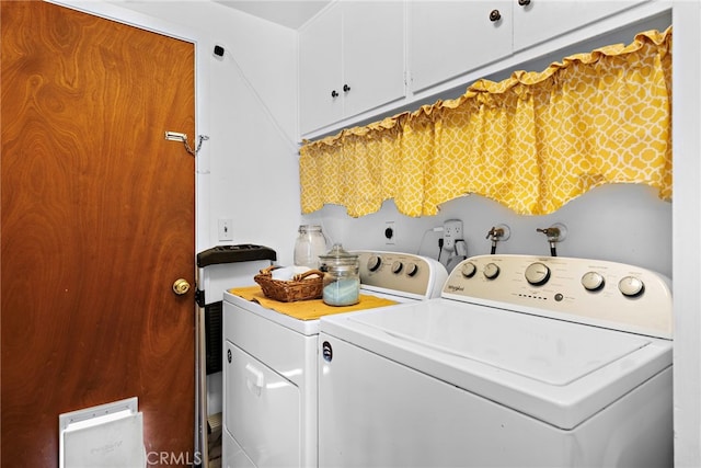 washroom featuring cabinet space and washer and dryer