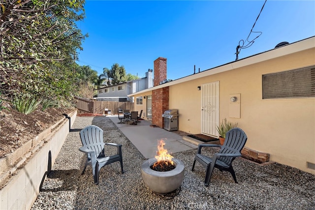 view of patio / terrace with a grill and a fire pit