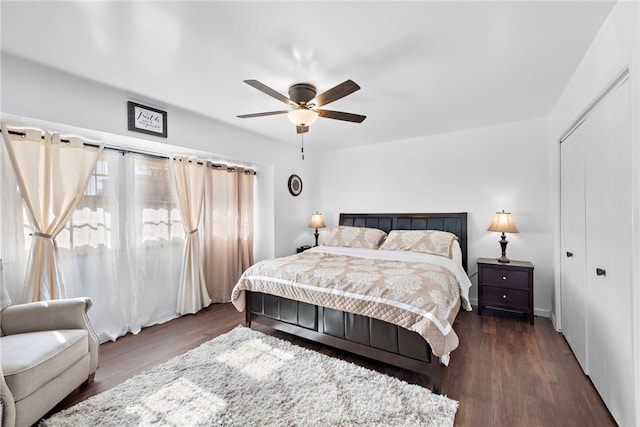 bedroom with a closet, dark wood finished floors, and ceiling fan