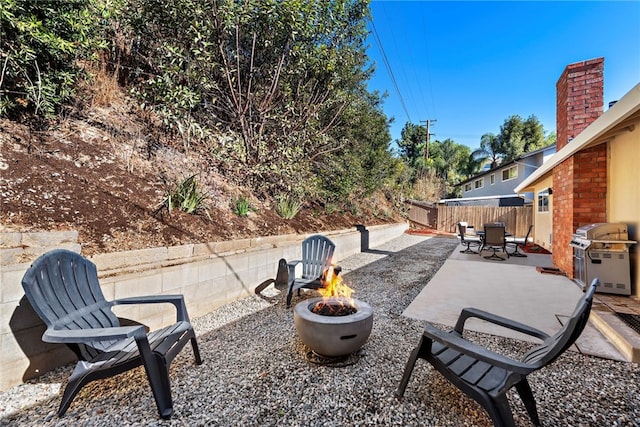 view of patio / terrace featuring an outdoor fire pit, area for grilling, and fence private yard