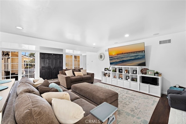 living area with visible vents, wood finished floors, baseboards, and recessed lighting