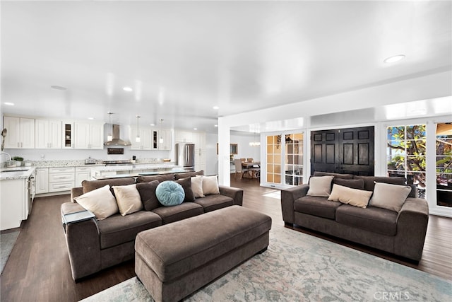 living room featuring dark wood-type flooring and recessed lighting