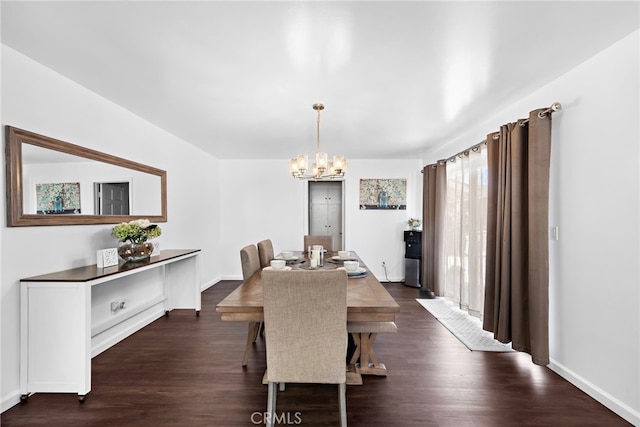 dining area featuring baseboards, a notable chandelier, and dark wood-style floors