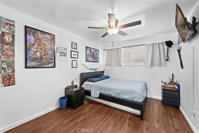 bedroom with ceiling fan and dark hardwood / wood-style flooring