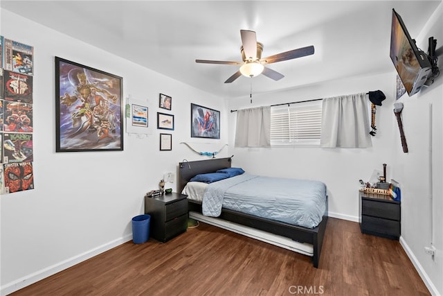 bedroom featuring baseboards, ceiling fan, and wood finished floors