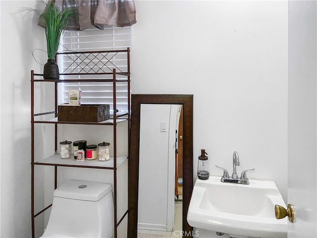 half bathroom featuring a sink and toilet
