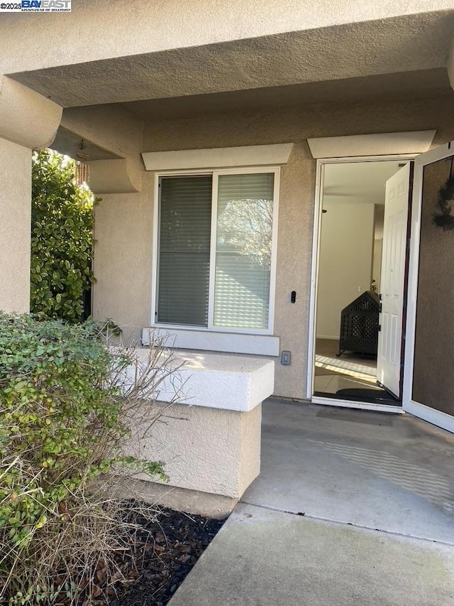 entrance to property featuring a patio