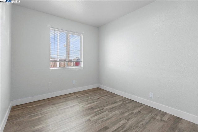 unfurnished room featuring hardwood / wood-style floors