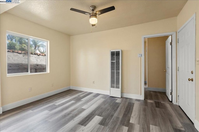 spare room featuring dark hardwood / wood-style flooring and ceiling fan