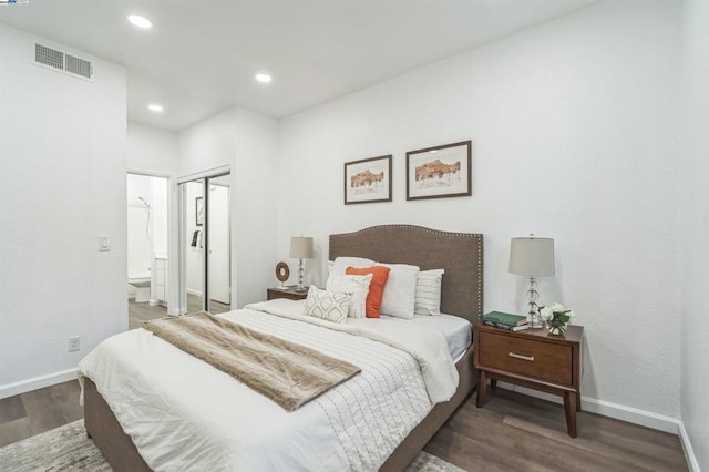 bedroom with a closet and dark hardwood / wood-style floors