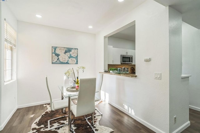 dining space with dark wood-type flooring