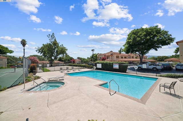 view of pool featuring a community hot tub and a patio area