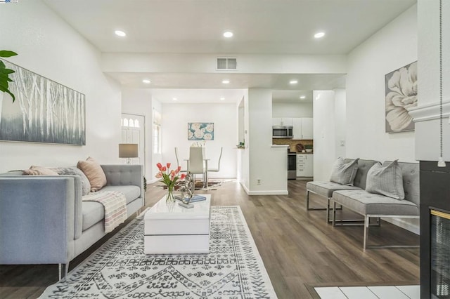 living room with dark hardwood / wood-style flooring